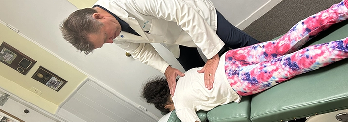 Chiropractor Reseda CA Bert Vanderbliek Adjusting Young Girl